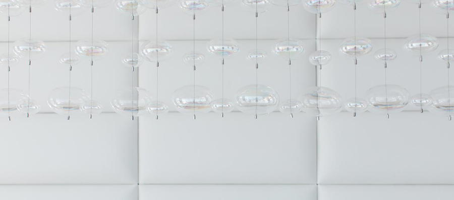 crypton-home-white leather wall and chandelier