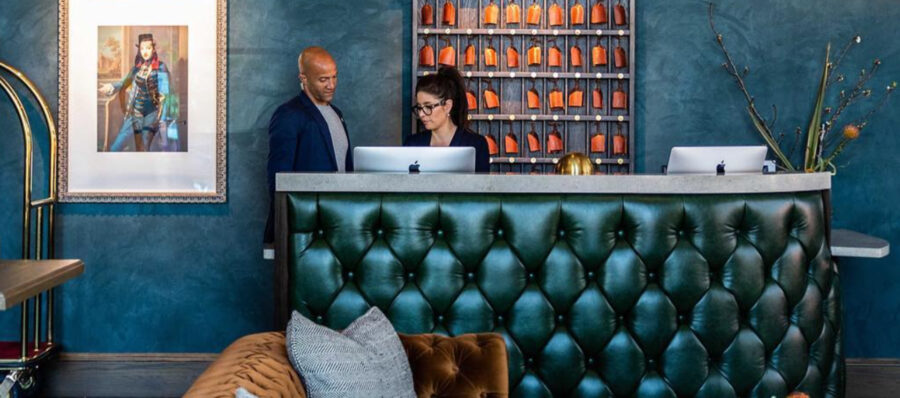 Cortina's Rustico Primavera in deep emerald green graces the tufted front desk at the RambleHotel designed by AvenueID.