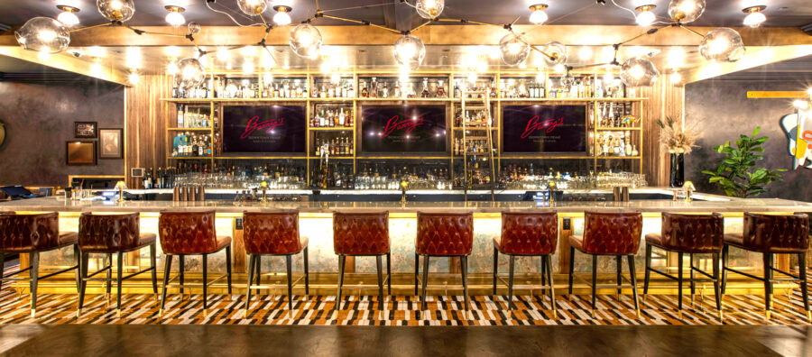 Cortina Leathers with strong Crypton protection. Barry's Downtown Prime restaurant and bar in Las Vegas with fully upholstered and deeply tufted bar stools using Cortina Leathers