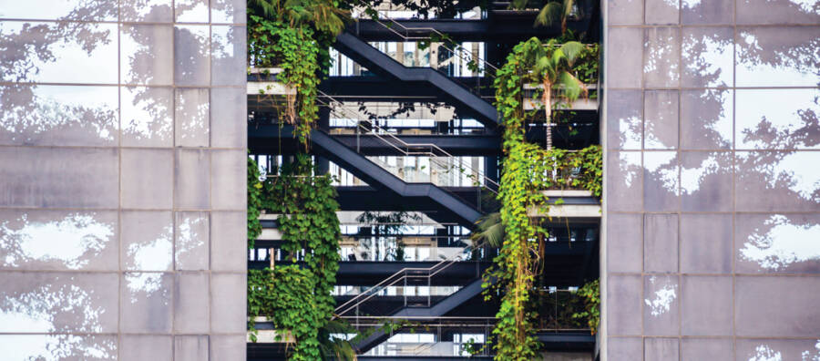 An image of a lovely high-rise with common walkways full of greenery is a link to a page about Cortina Leathers' commitment to environmental stewardship.