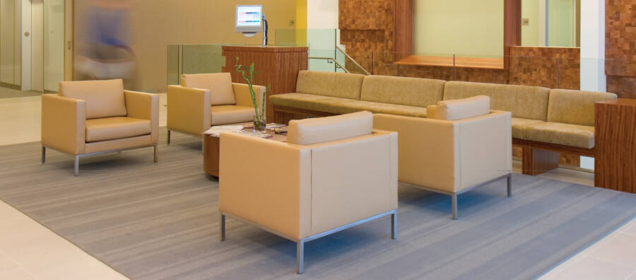An image of an office common area with lovely light beige chairs is a link to a page with FAQs.