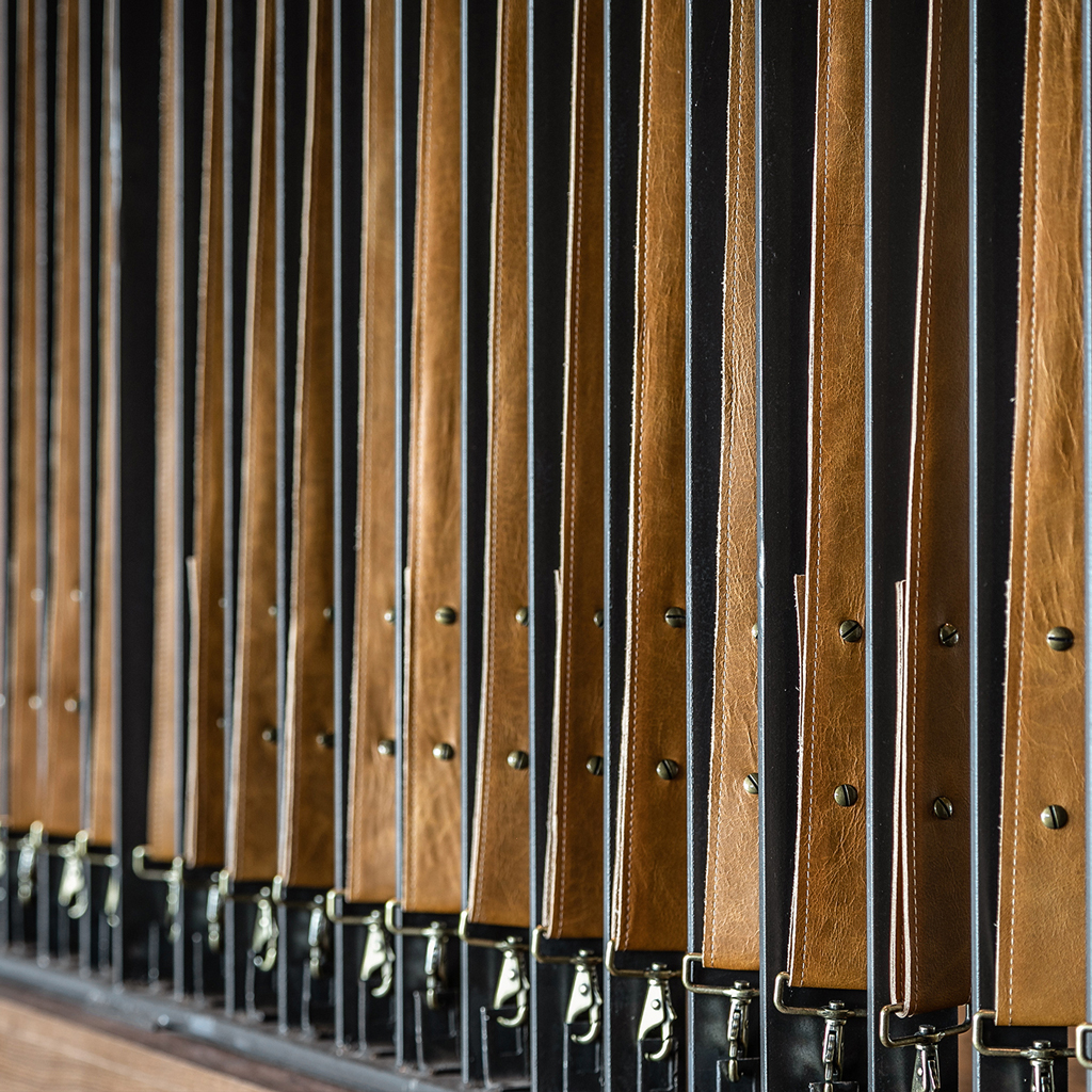 A tan Cortina leather was made into straps and used for a unique stair and landing railing feature rather than metal cable or or wood baluster.