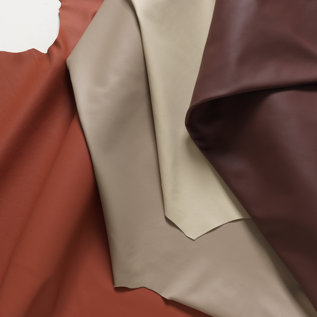 Cortina's Azzurro collection is a soft Italian pigmented leather shown here in a sophisticated pallet of orange burgundy and beige neutrals